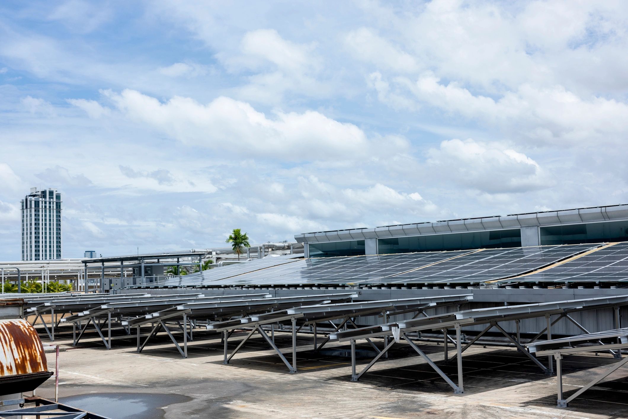 Solar panels installed on a rooftop in a bright coastal setting